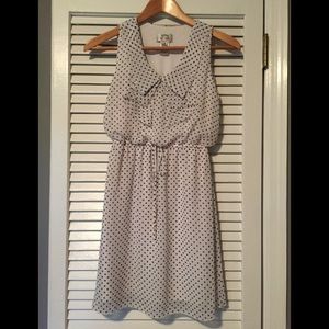 White dress with Black polka dots. Ties at waist
